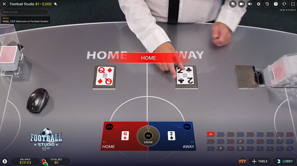 Football Studio live dealer table showing a Queen of Diamonds dealt to Home and a 2 of Clubs dealt to Away, with Home winning the round