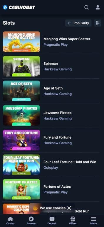 CasinoBet mobile slots page displaying popular games including Mahjong Wins Super Scatter by Pragmatic Play, Spinman by Hacksaw Gaming, Age of Seth, Jawsome Pirates, Fury and Fortune, Four Leaf Fortune Hold and Win by Octoplay, Fortune of Aztec, and Majestic Explorer Gold Run, sorted by popularity with game thumbnails and developer names