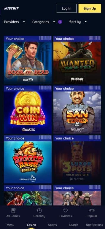 JustBit Casino games lobby showing popular slots including Book of Dead, Wanted Dead or Wild, San Quentin, and Coin Win from top providers like Play'n GO, Hacksaw Gaming, and Nolimit City