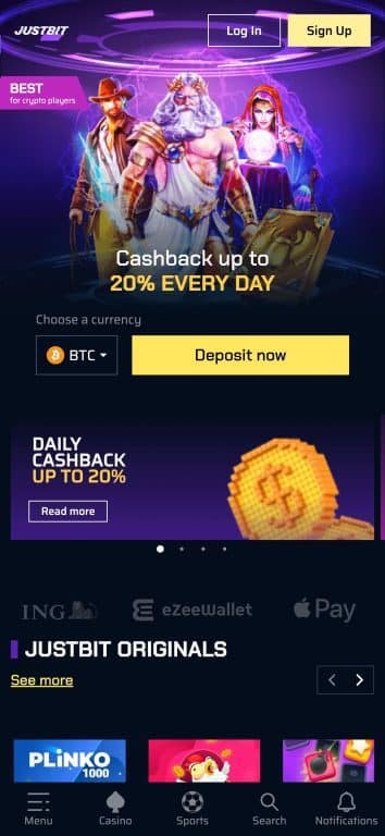JustBit Casino homepage featuring cyberpunk design with 20% daily cashback promotion, Bitcoin deposit option, and fantasy-themed slot characters